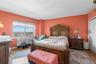 Expansive room featuring a large window, light-toned wood-finish flooring,