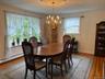 Dining space featuring wood finished floors and a chandelier