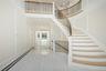 Foyer entrance with a towering ceiling, recessed lighting, stairs, marble tiled flooring, and inlaid floor details