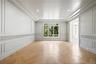 Empty room with a decorative wall, a tray ceiling, and recessed lighting