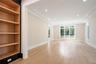 Empty room featuring light wood-style flooring, recessed lighting, a tray ceiling, and built in features