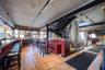 Indoor dry bar featuring track lighting, tile patterned flooring, and healthy amount of natural light