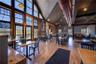 Dining area with wood finished floors and a high ceiling