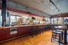 Bar area with tile patterned floors and rail lighting
