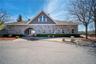View of front facade with stone siding and french doors