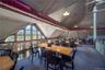 Carpeted dining room with lofted ceiling