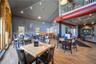 Dining room featuring a towering ceiling, wood finished floors, and rail lighting