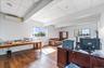 Office space featuring beam ceiling, hardwood / wood-style flooring, healthy amount of natural light, and a wall mounted air conditioner
