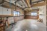 Below grade area with concrete block wall and healthy amount of natural light