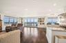 Living area featuring a water view, recessed lighting, baseboards, and dark wood finished floors