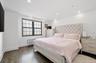 Bedroom with crown molding, recessed lighting, an AC wall unit, baseboards, and dark wood finished floors