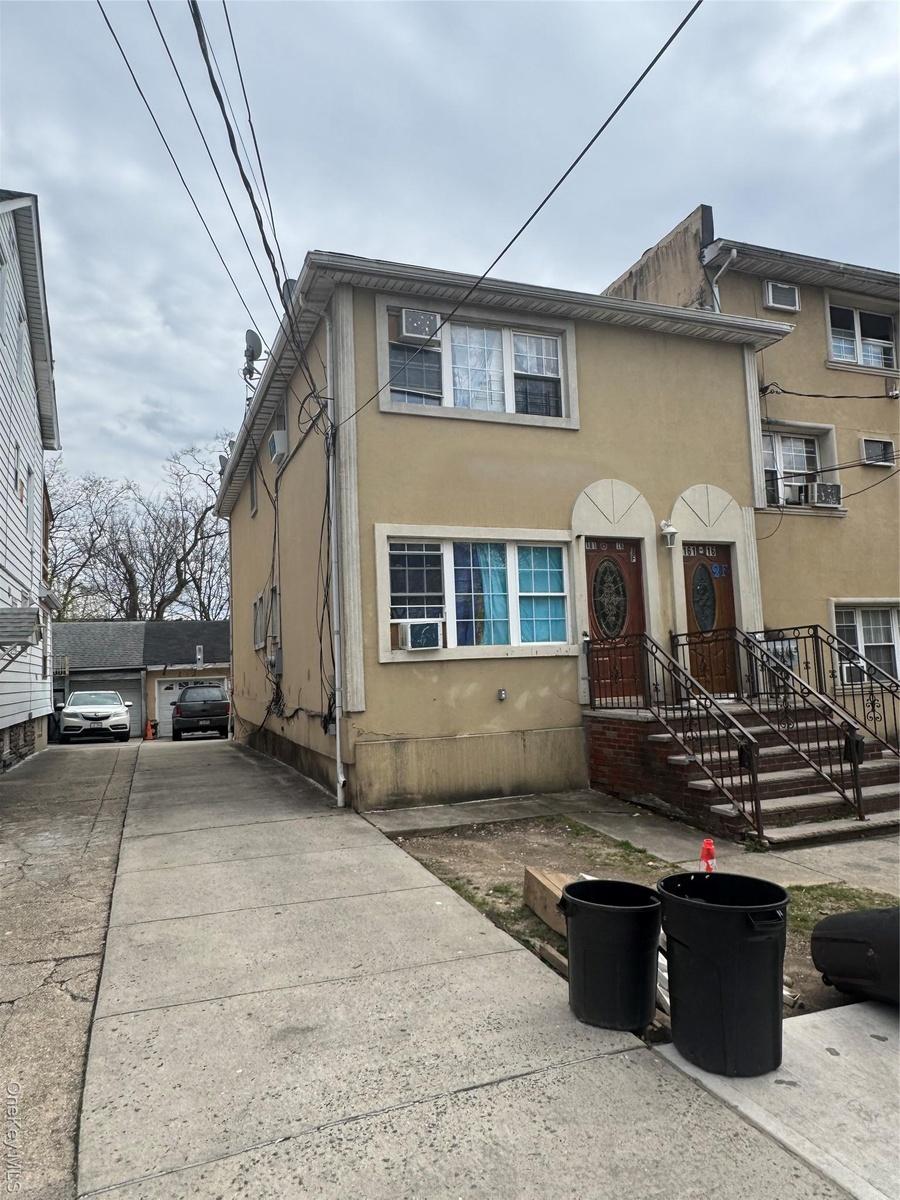 Multi unit property with stucco siding and cooling unit