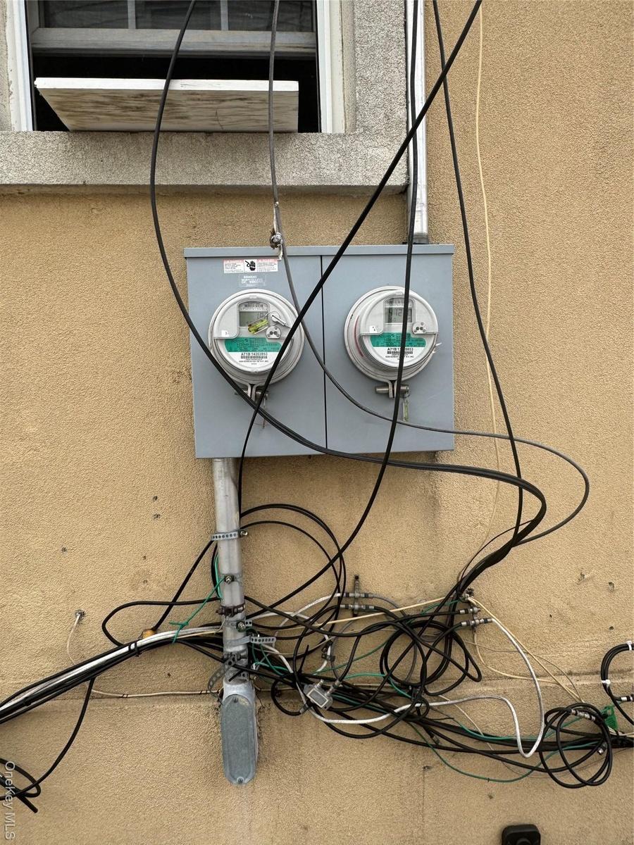 Details featuring electric meter and stucco siding