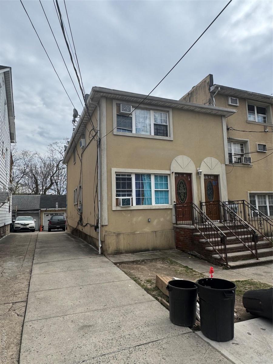 Townhome / multi-family property with stucco siding and cooling unit