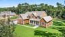 Shingle-style home featuring a porch and roof with shingles