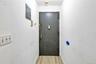 Doorway with electric panel and baseboards
