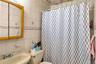 Full bathroom with tile walls, a shower with curtain, and tasteful backsplash