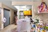 Kitchen featuring freestanding refrigerator, brown cabinetry, and decorative backsplash