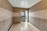Bathroom with tile patterned flooring, baseboard heating, and tile walls