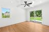 Unfurnished room with beamed ceiling, plenty of natural light, light wood-style floors, coffered ceiling, and crown molding
