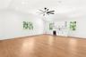 Unfurnished living room with vaulted ceiling, plenty of natural light, light wood-type flooring, recessed lighting, and wine cooler