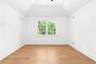 Unfurnished room with light wood finished floors, ceiling fan, and vaulted ceiling