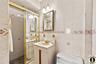 Full bath with a stall shower, tile walls, and vanity
