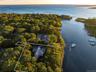 Aerial view at dusk of a water view and property parcel outlined