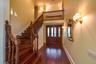 Foyer entrance with dark wood-type flooring, a high ceiling, and stairway