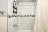 Full bath featuring tiled shower