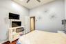 Bedroom featuring dark wood-type flooring, a ceiling fan, and arched walkways
