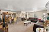 Living room featuring hanging lights, arched walkways, and light colored carpet