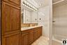 Bathroom featuring double vanity, tile walls, tasteful backsplash, and recessed lighting- Tons of Storage Space- Excellent Quality Workmanship.