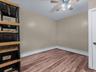 Spare room with light wood-style flooring, a baseboard heating unit, and a ceiling fan