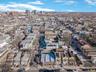 Aerial view of property and surrounding area with nearby urban area