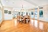 Huge Dining area with healthy amount of natural light, light wood-type flooring, a chandelier, and recessed lighting. Doors out to very large deck.