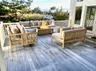 Ai Added furniture. Wooden terrace with an outdoor living space with a fire pit
