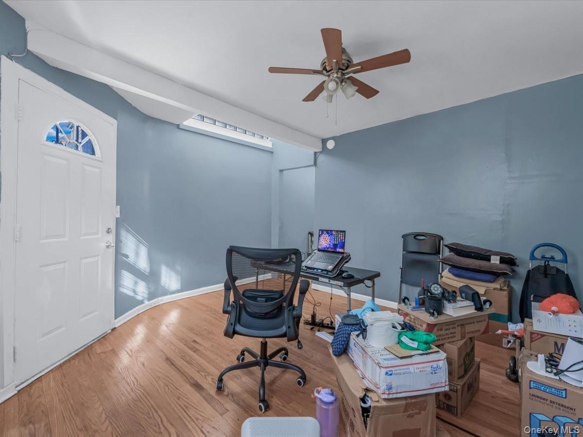 Home office with wood finished floors and ceiling fan