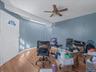 Home office with wood finished floors and ceiling fan