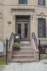 Doorway to property featuring brick siding