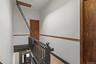 Staircase with wood finished floors and baseboards