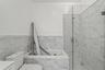 Bathroom featuring a bath, a shower stall, vanity, tile walls, and a wainscoted wall