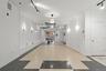 Hallway with rail lighting and inlaid floor details