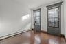 Unfurnished room with baseboard heating, dark wood-style flooring, and cooling unit