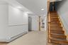 Stairway featuring a baseboard heating unit and recessed lighting