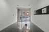 Hallway with a wall of windows and baseboards