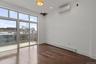 Empty room featuring a baseboard heating unit, dark wood-style floors, an AC wall unit, and recessed lighting