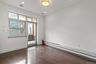 Unfurnished room featuring a baseboard radiator, dark wood-style floors, and recessed lighting
