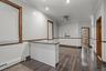 Spare room with a baseboard heating unit, ornamental molding, dark wood-style flooring, and ceiling fan
