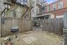 Fenced backyard featuring a patio and a grill